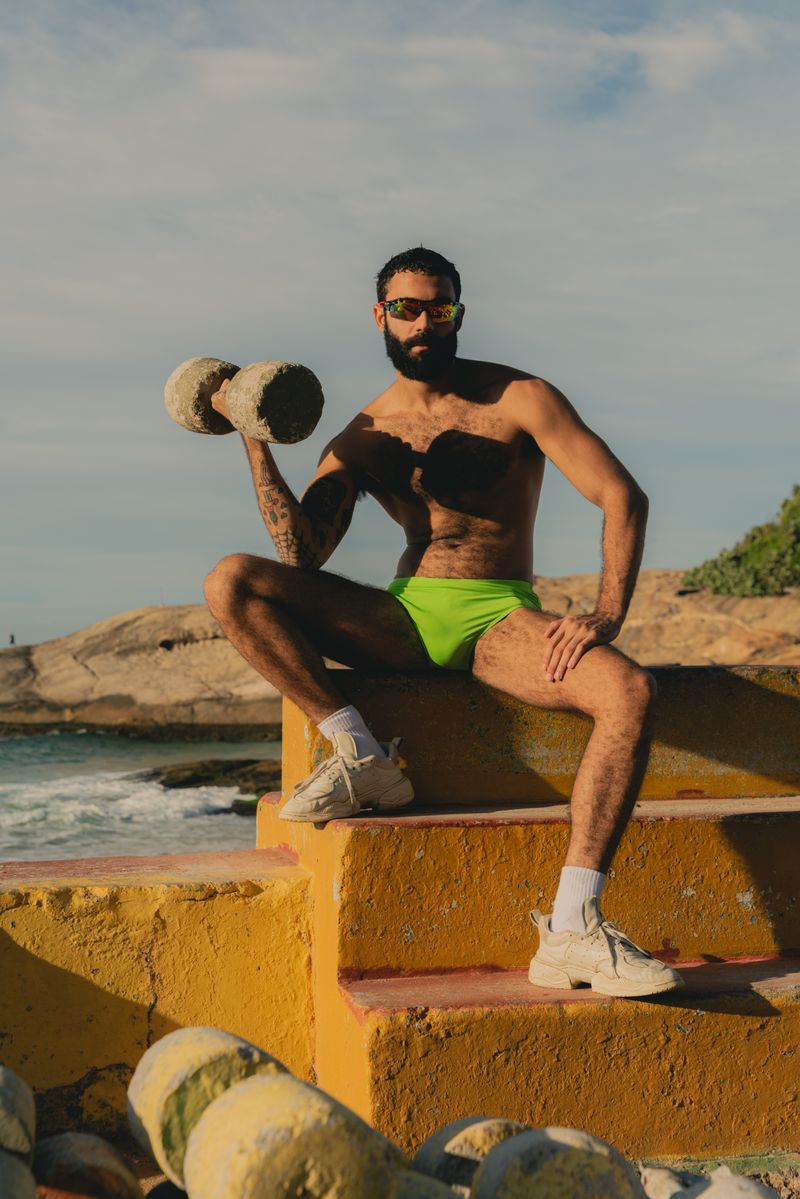 malhando na academia ao ar livre do arpoador homem levantando peso de pedra na academia ao ar livre do arpoador