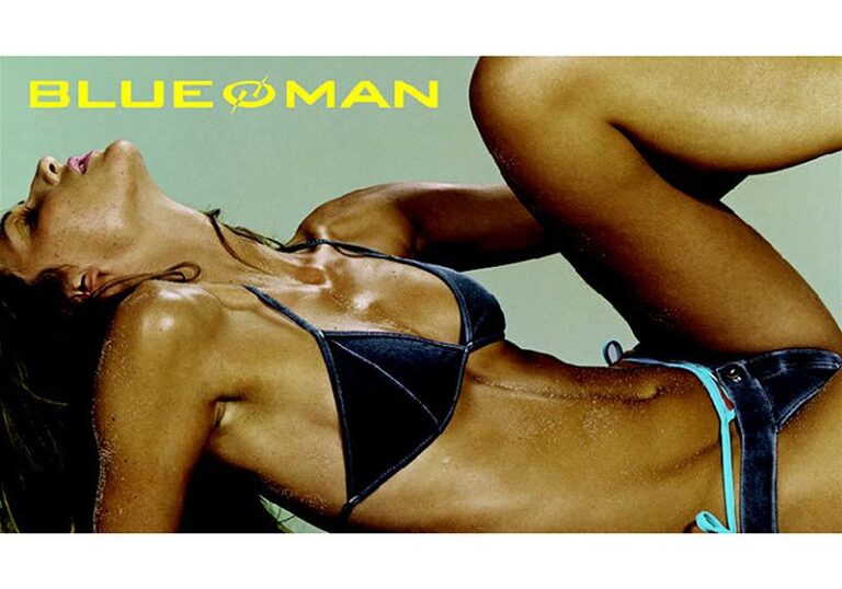 Mulher deitada com uma perna erguida vestida com biquíni jeans